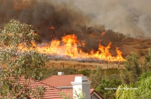 A fire that came dangerously close to several Los Angeles County homes is now 50 percent contained after burning 30 acres.