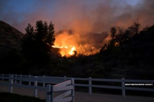 That brush fire in Murrieta continue to grow beyond 14-acres as nervous homeowners watch flames get closer to their neighborhoods.