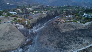 Southern California Edison is agreeing to pay 210-million dollars to settle lawsuits tied to the massive Woolsey Fire.