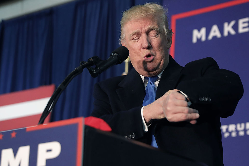 LEESBURG, VA - NOVEMBER 07:  Republican presidential nominee Donald Trump checks his watch and announces it is a "Midnight rally," during a campaign stop at the Loudoun County Fairgrounds in the early morning hours on November 7, 2016 in Leesburg, Virginia. With less than 48 hours until Election Day in the United States, Trump and his opponent, Democratic presidential nominee Hillary Clinton, are campaigning in key battleground states that each must win to take the White House.  (Photo by Chip Somodevilla/Getty Images)